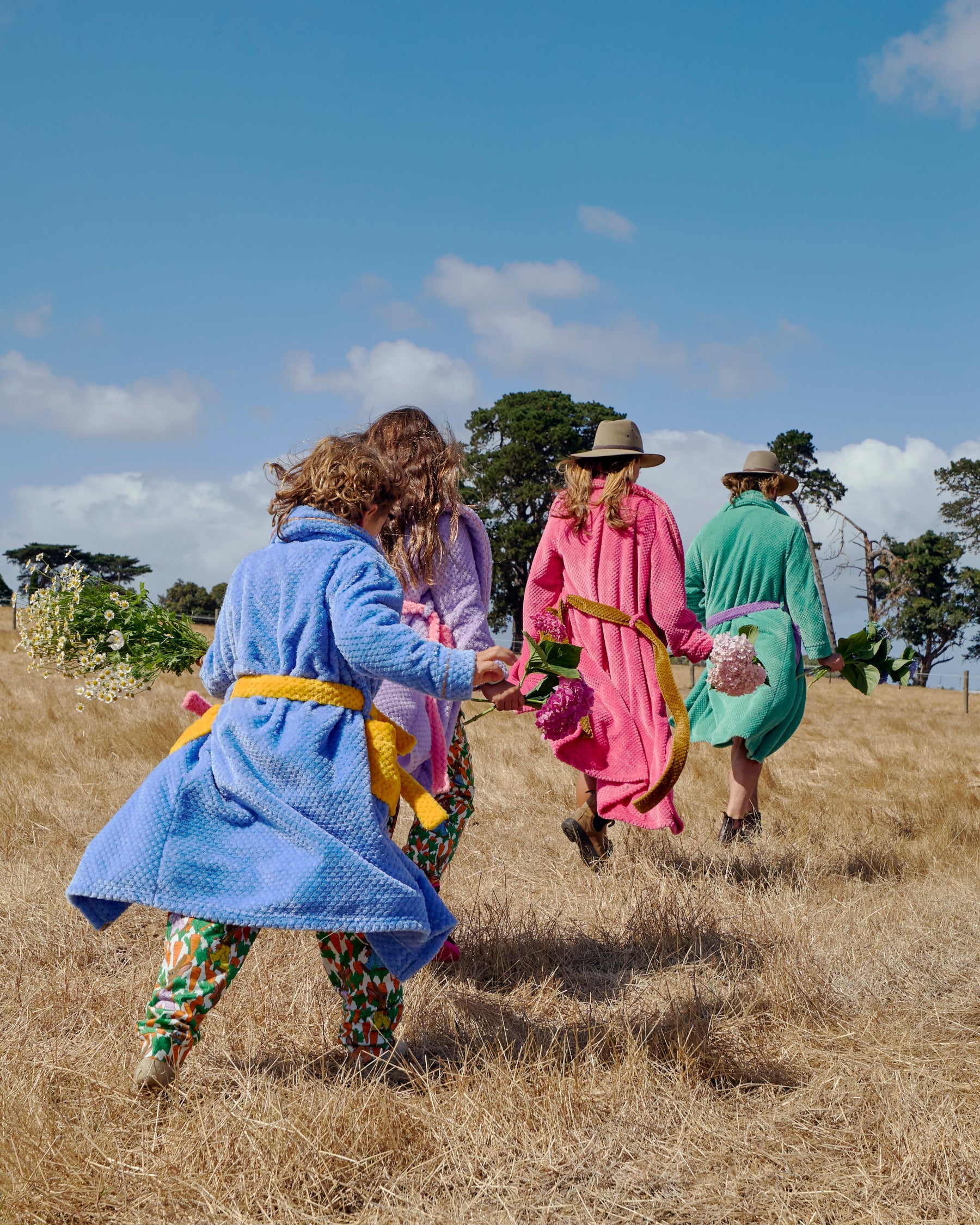 Boy lounging in blue Seaside Kids Cosy Robe by Kip & Co on bean bag chair showing comfort fit