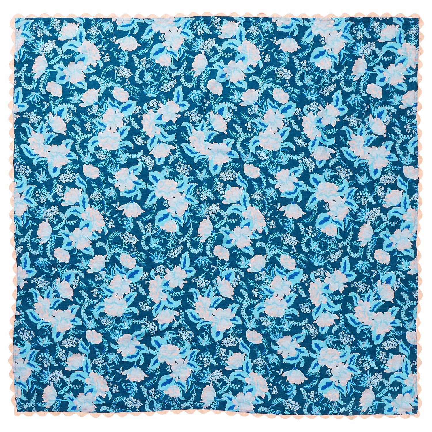 Flat-lay of square teal and blush floral tablecloth with peach scalloped border
