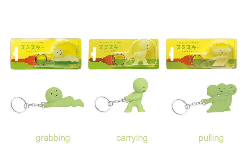 3 different smiski key chains - grabbing, carrying and pulling