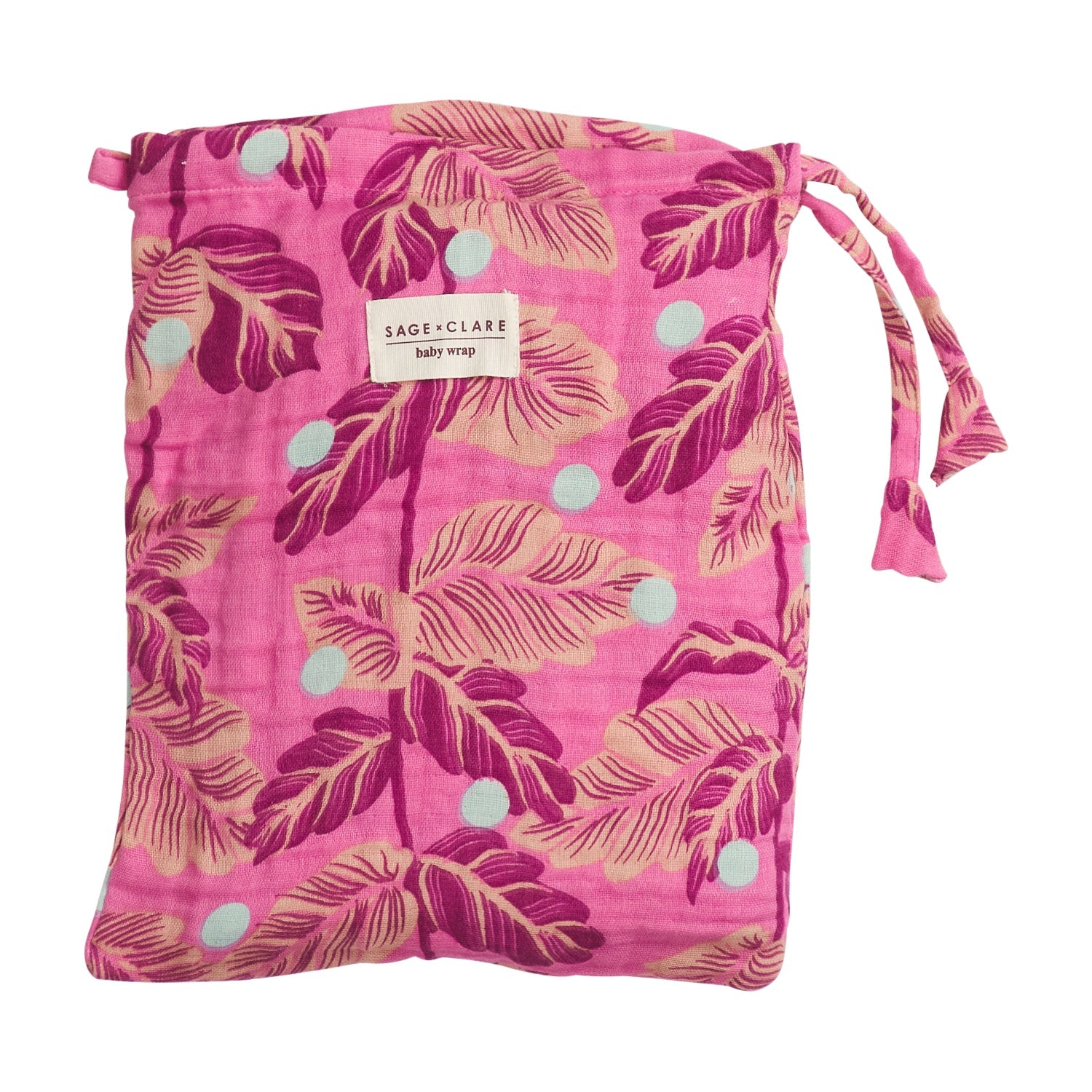 Pink baby wrap folded in drawstring storage bag with tropical leaf print and brand label