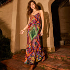 Full-length view of bold patchwork floral cami top styled as a maxi with spaghetti straps