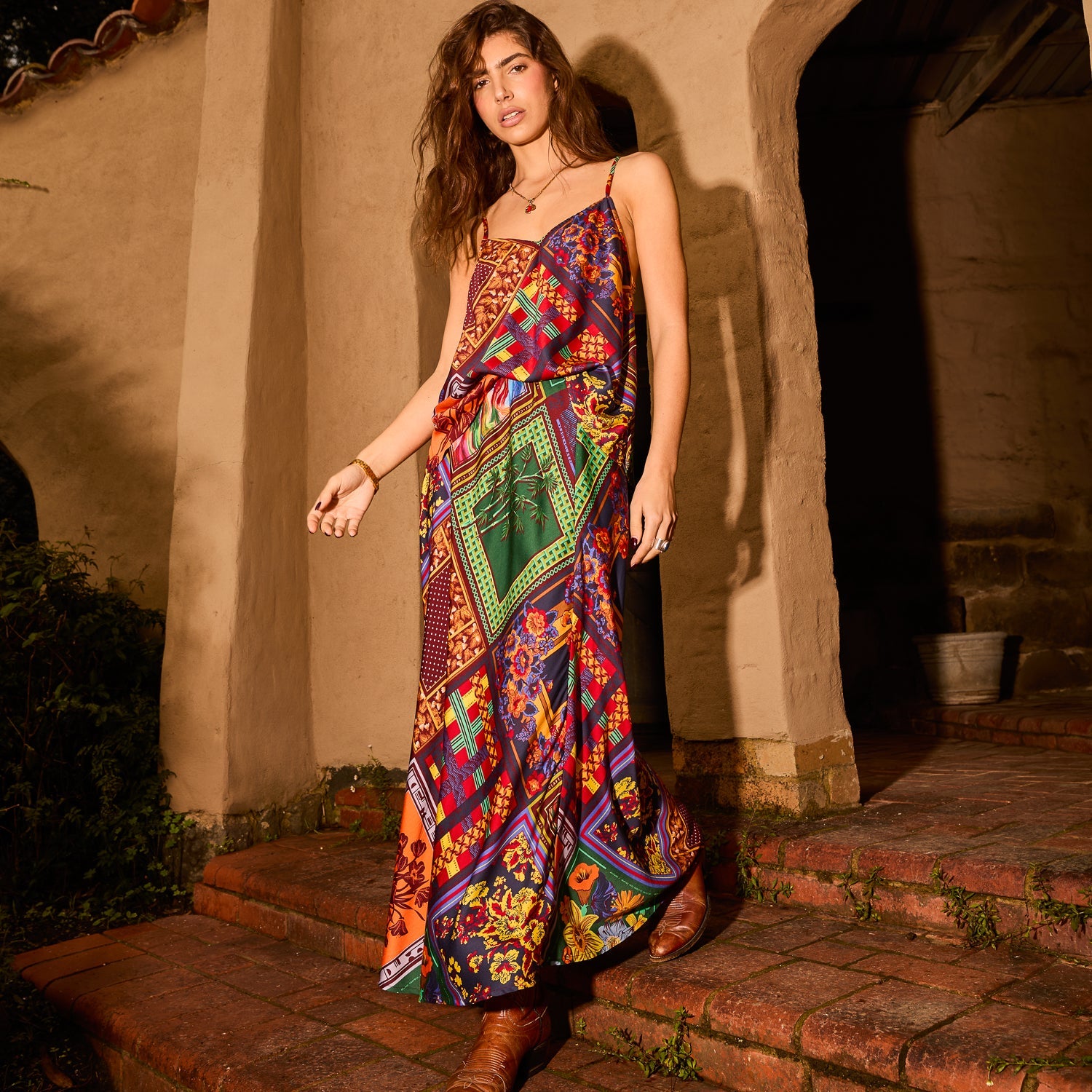 Full-length view of bold patchwork floral cami top styled as a maxi with spaghetti straps