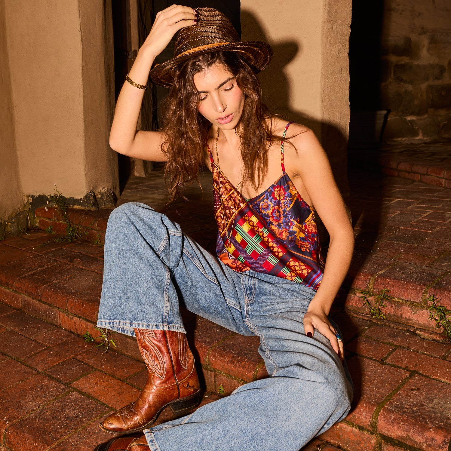 V-neck multiprint satin cami top with spaghetti straps, paired with jeans, seated close-up
