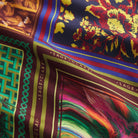 Close-up of the multicolour patchwork-print satin fabric showing floral, geometric and striped panel details