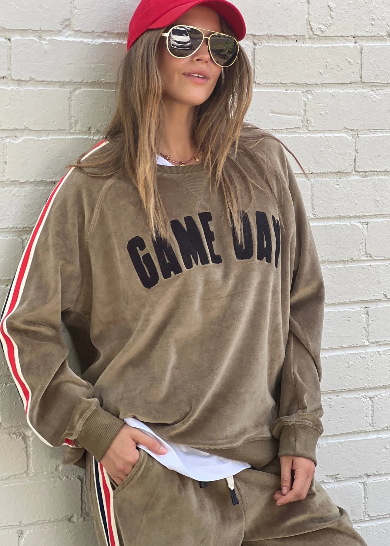 Model wearing velour game day Khaki sweat by Hammill& Co