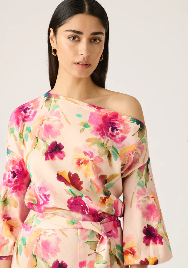 Model wearing off the should knit dress with floral print by MOS The label.