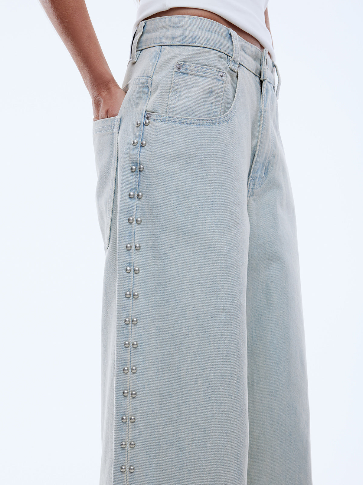 wide leg light blue jeans with stud detailing