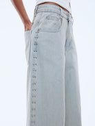 wide leg light blue jeans with stud detailing