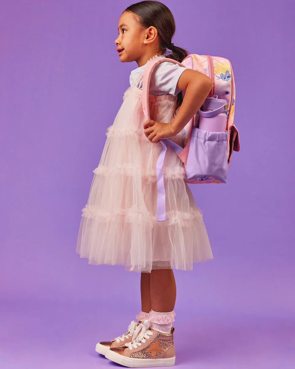 side view of girl with Stitch Mini Adventure Backpack by The Somewhere Co
