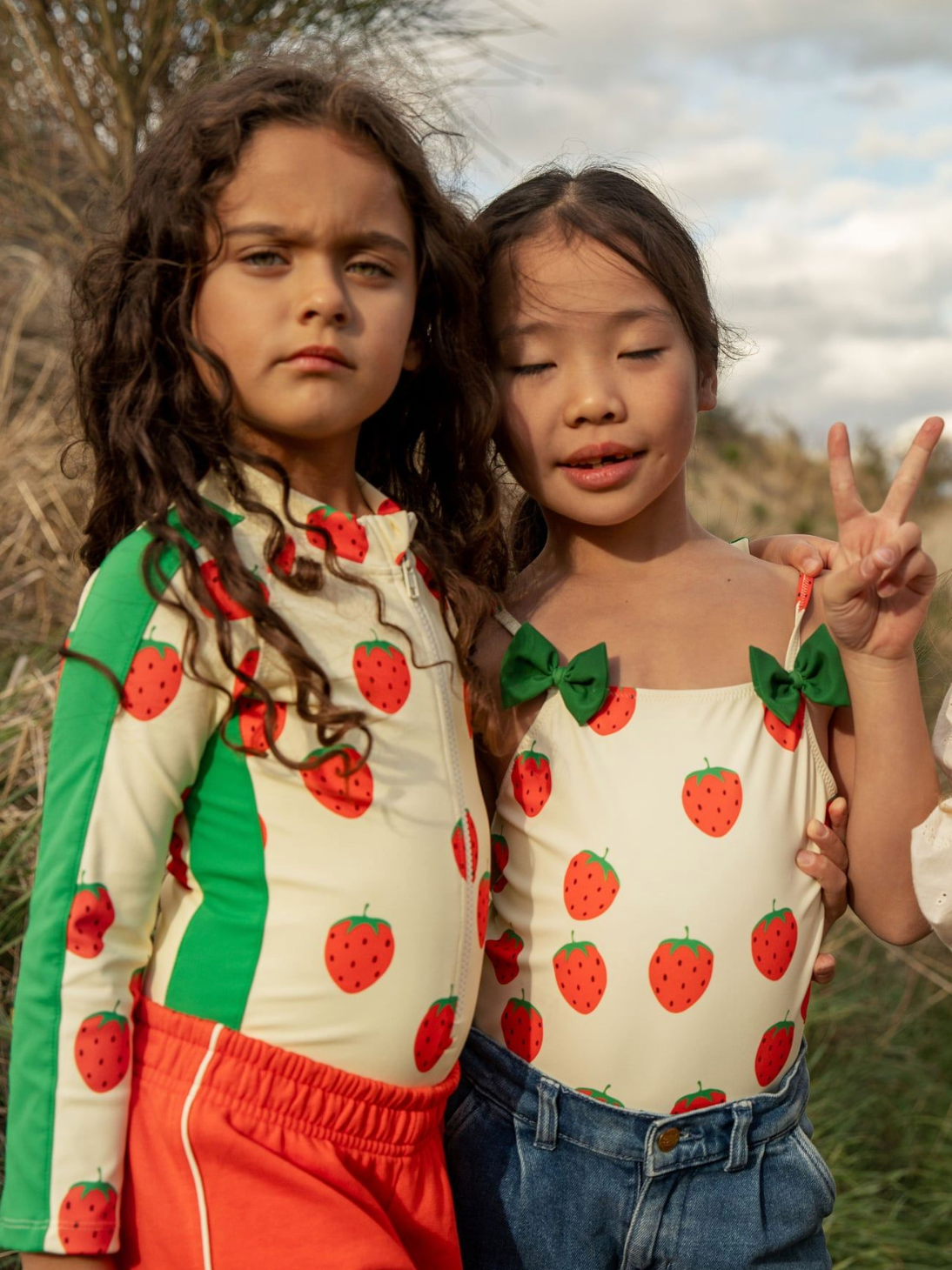 Girl wearing Strawberries aop ls uv swimsuit - Off-white| Mini Rodini