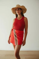 model wearing Stripe Knit Skirt – Red by By Billie. Red woven skirt with brown stripe