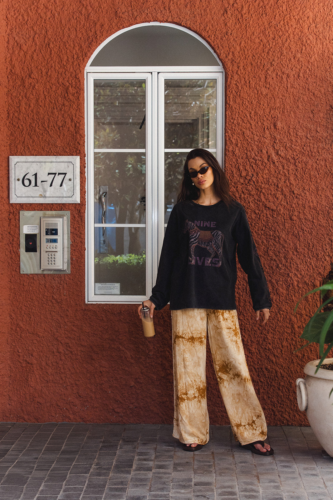 Side profile view of Sunday Pants highlighting crochet lace trim and tie-dye pattern