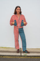 Full-length front view of pink and blue two tone corduroy bomber jacket showing relaxed oversized fit and zip closure