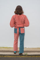 Back view of two tone pink and blue corduroy surf bomber jacket showing ribbed corduroy texture and relaxed fit