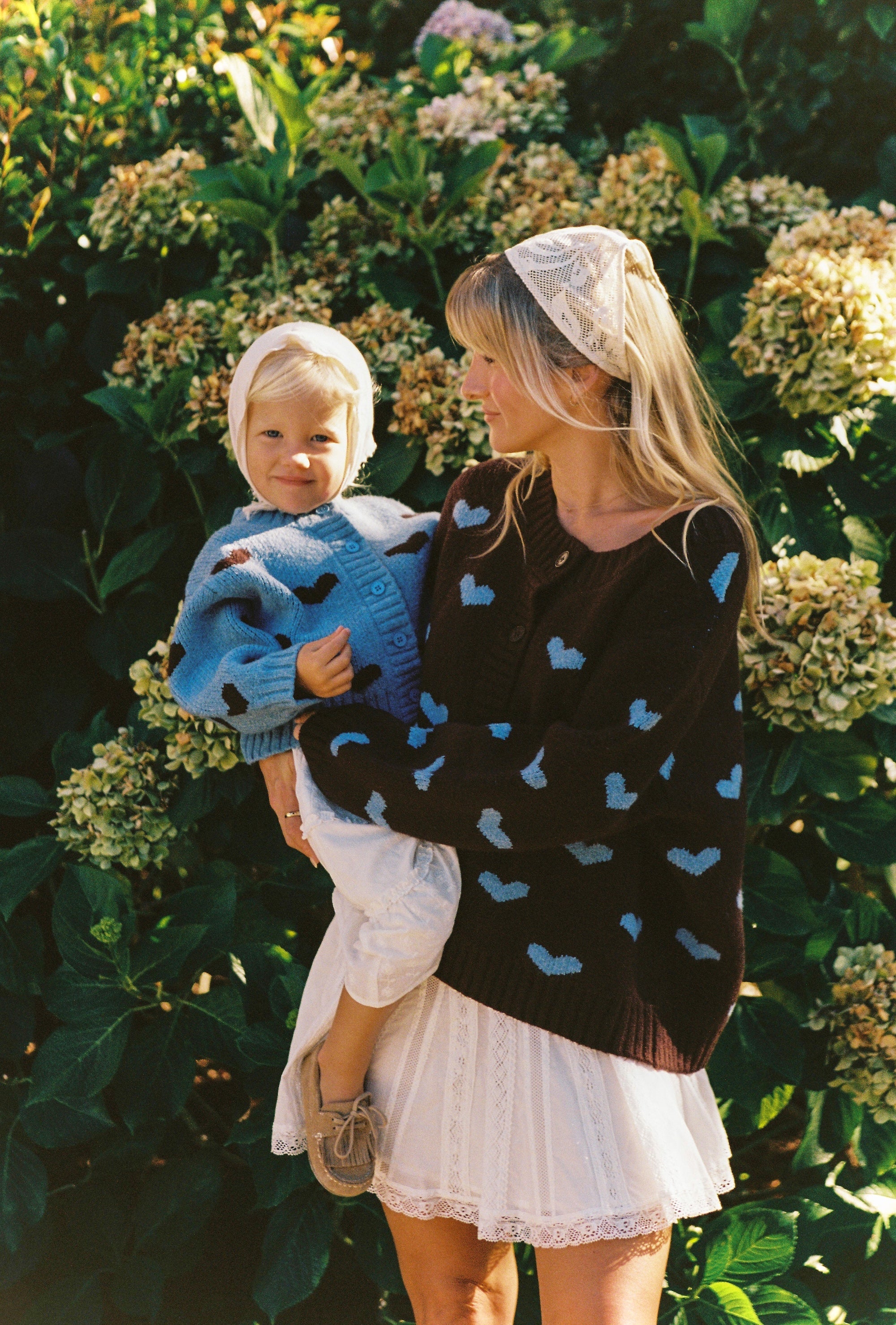 mum wearing Juni Hearts pattern knit cardigan relaxed fit button down and daughter wearing matching cardigan