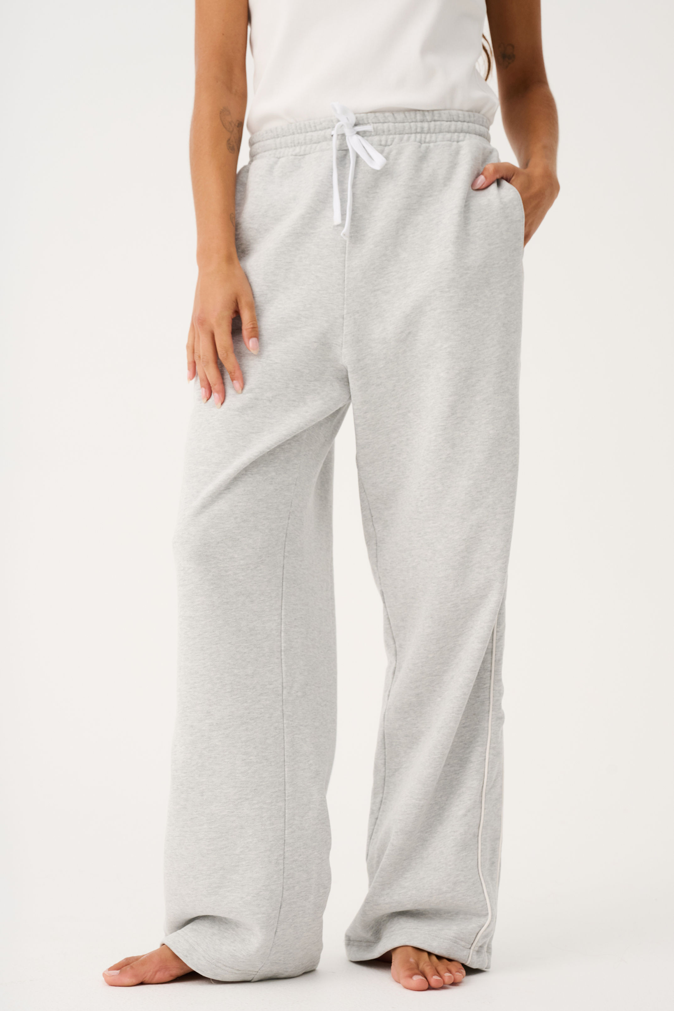Front view of Teagan Track Pant in grey marle showing elastic waistband with white drawstring and side pockets