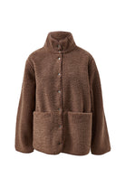 Flat lay of chocolate brown teddy jacket showing fuzzy sherpa texture and snap button front closure