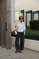 Woman styling marshmallow teddy jacket open over white tee with casual street look