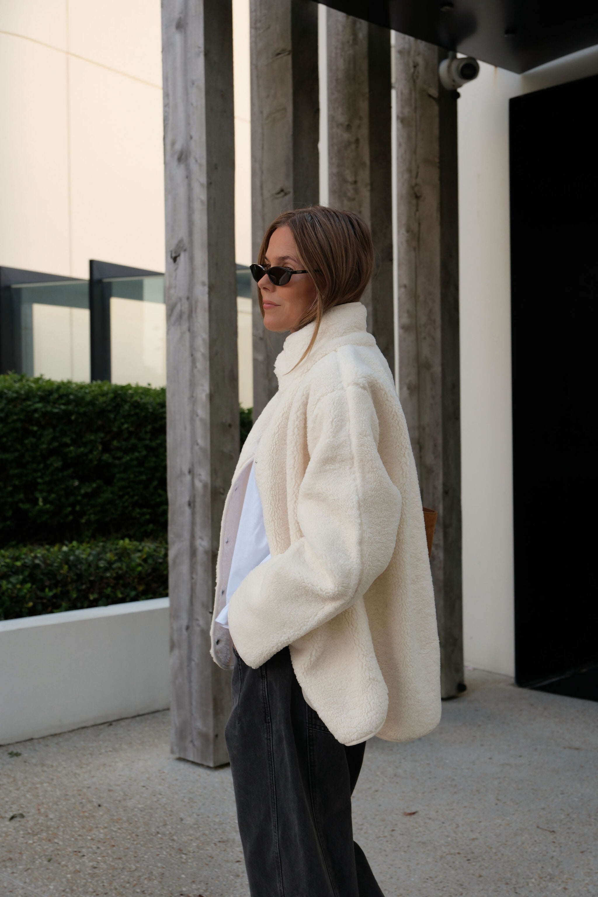 Side profile of woman in marshmallow teddy jacket showing relaxed oversized fit