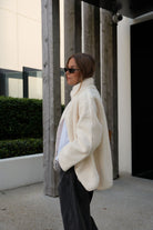 Side profile of woman in marshmallow teddy jacket showing relaxed oversized fit