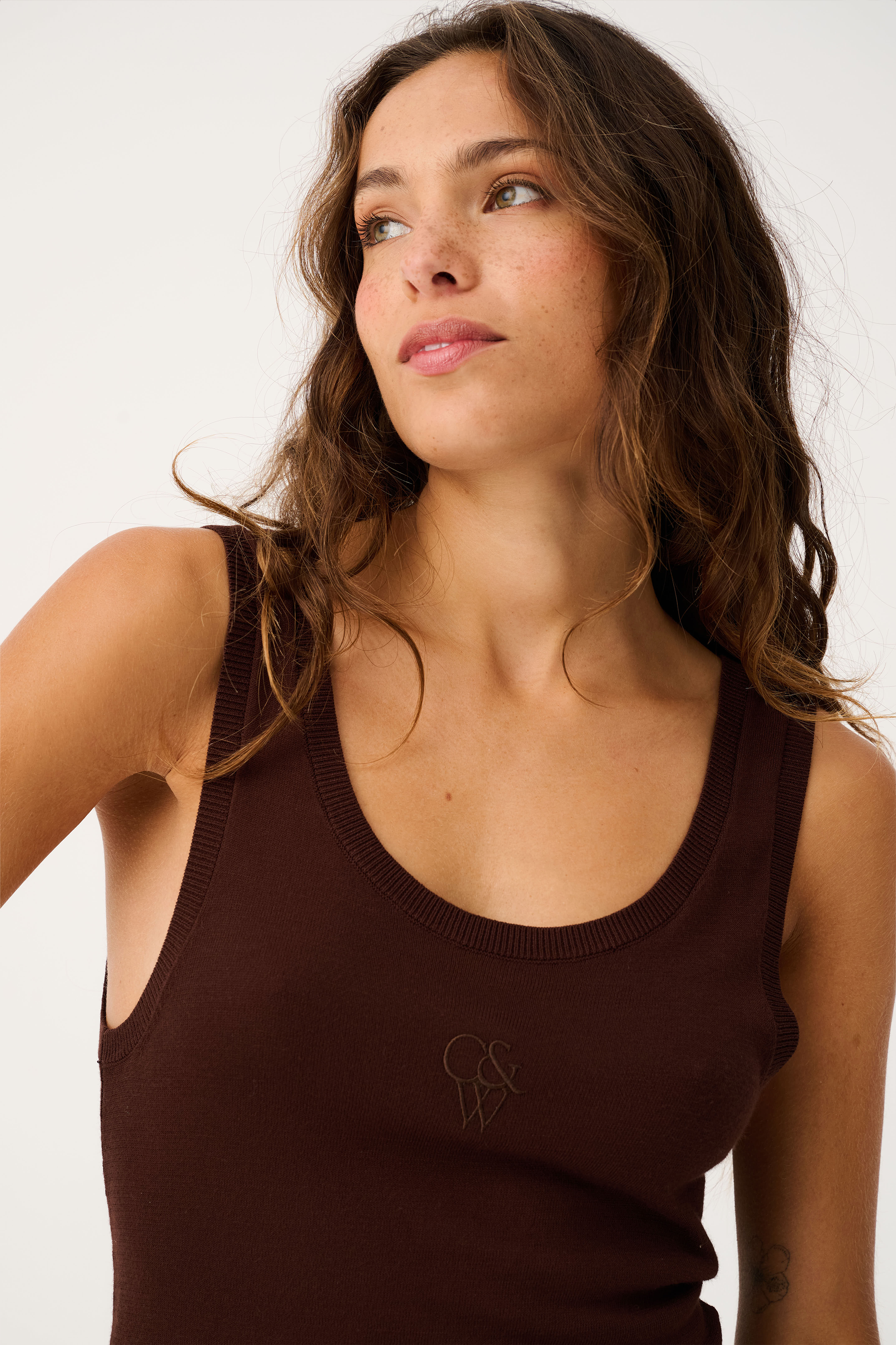 Close-up front angle of Thea Knit Tank in truffle brown with ribbed scoop neck and logo embroidery