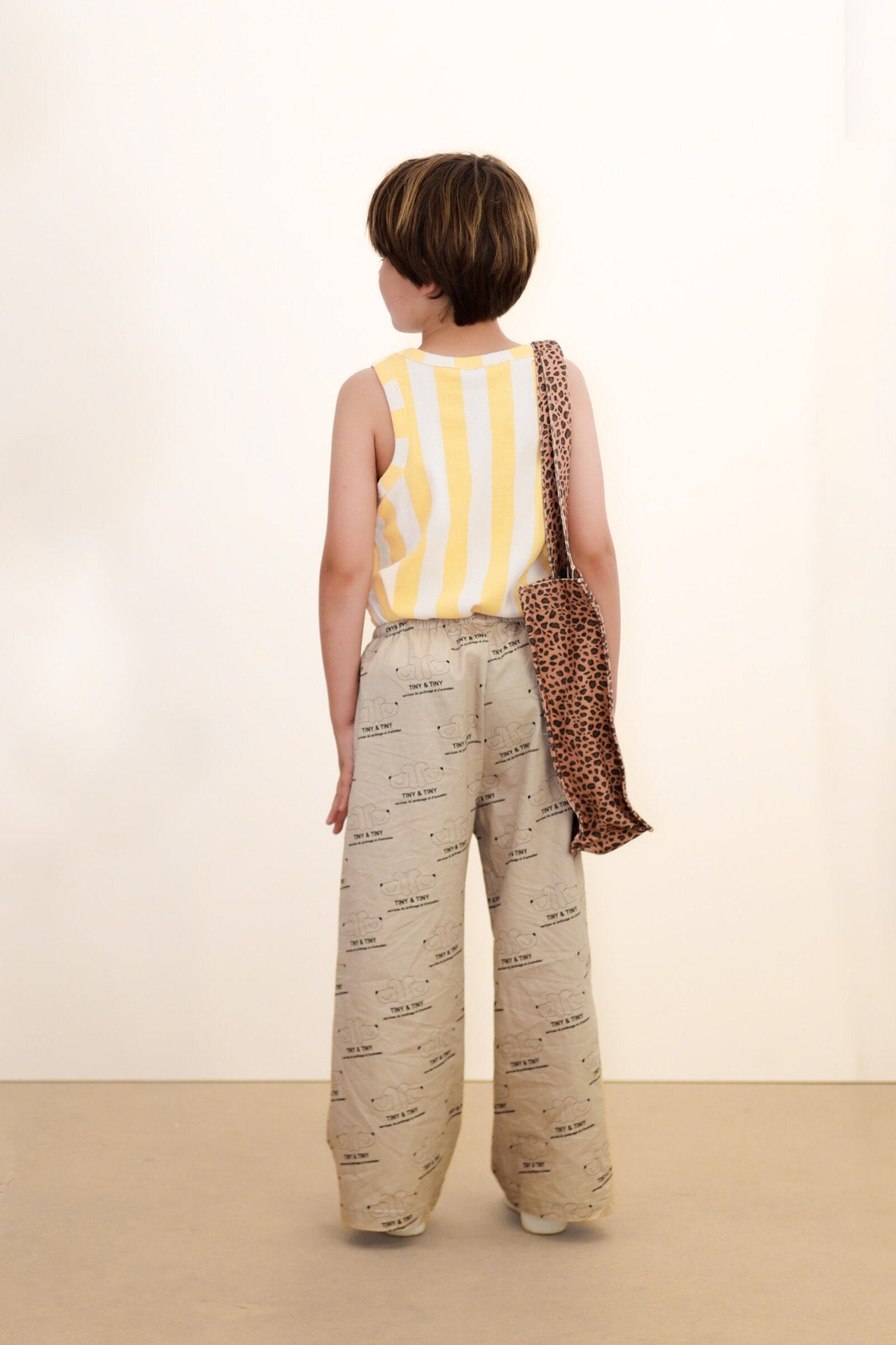 back of boy wearing Tiny & Tiny Twill Pant – Dark Vanilla by Tiny Cottons - beige pants with dog graphic