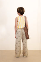 back of boy wearing Tiny & Tiny Twill Pant – Dark Vanilla by Tiny Cottons - beige pants with dog graphic