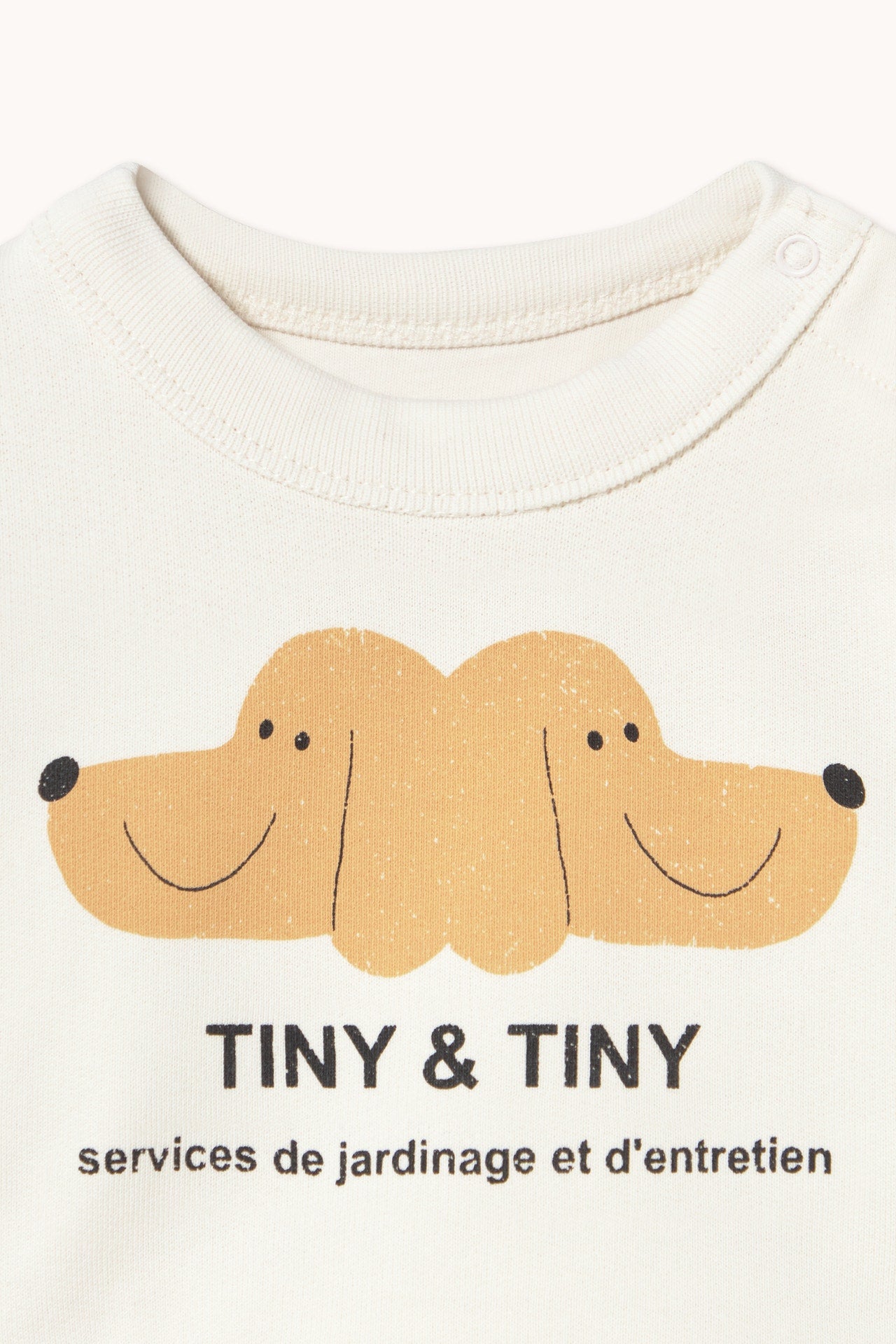 Close up of dog print on the Tiny & Tiny Baby Sweatshirt - Off-White | Tiny Cottons