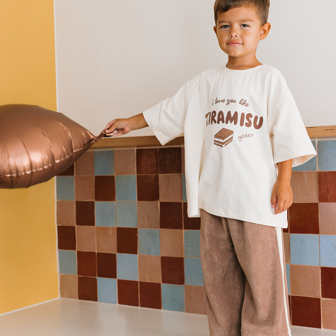 Young boy wearing the Tiramisu T-shirt - Buttercream | Golden Children