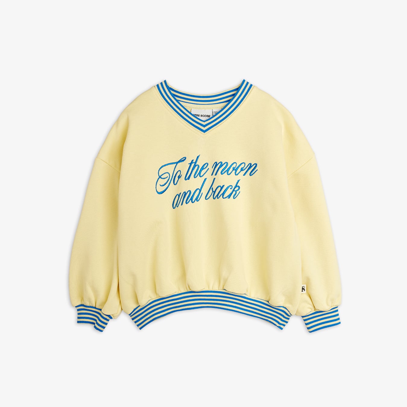 Flat lay of mini rodini To the Moon yellow sweatshirt showing blue striped v-neck and cuffs