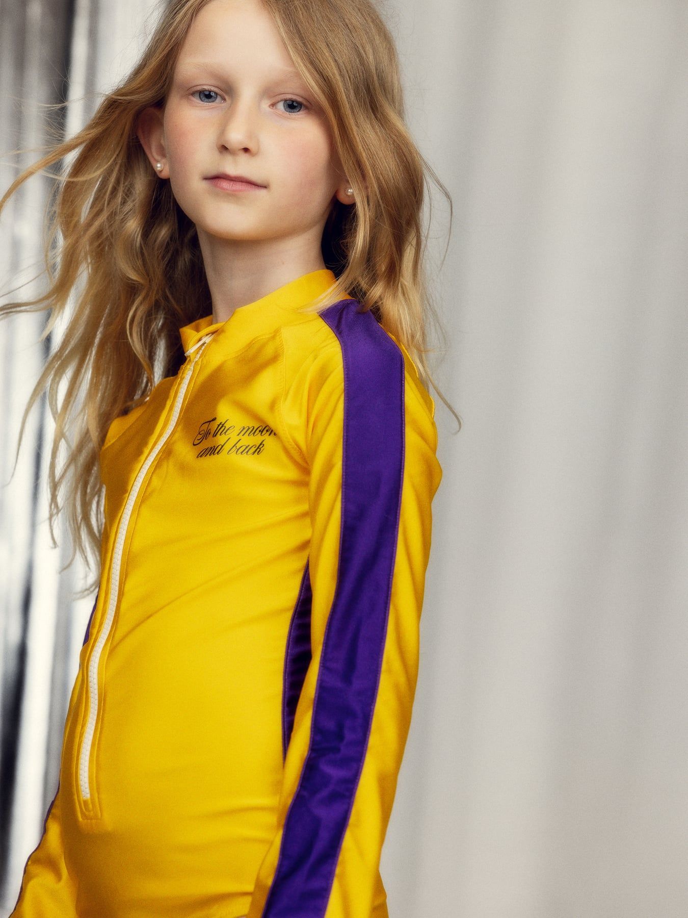 girl wearing To the Moon UV Swimsuit Yellow by Mini Rodini
