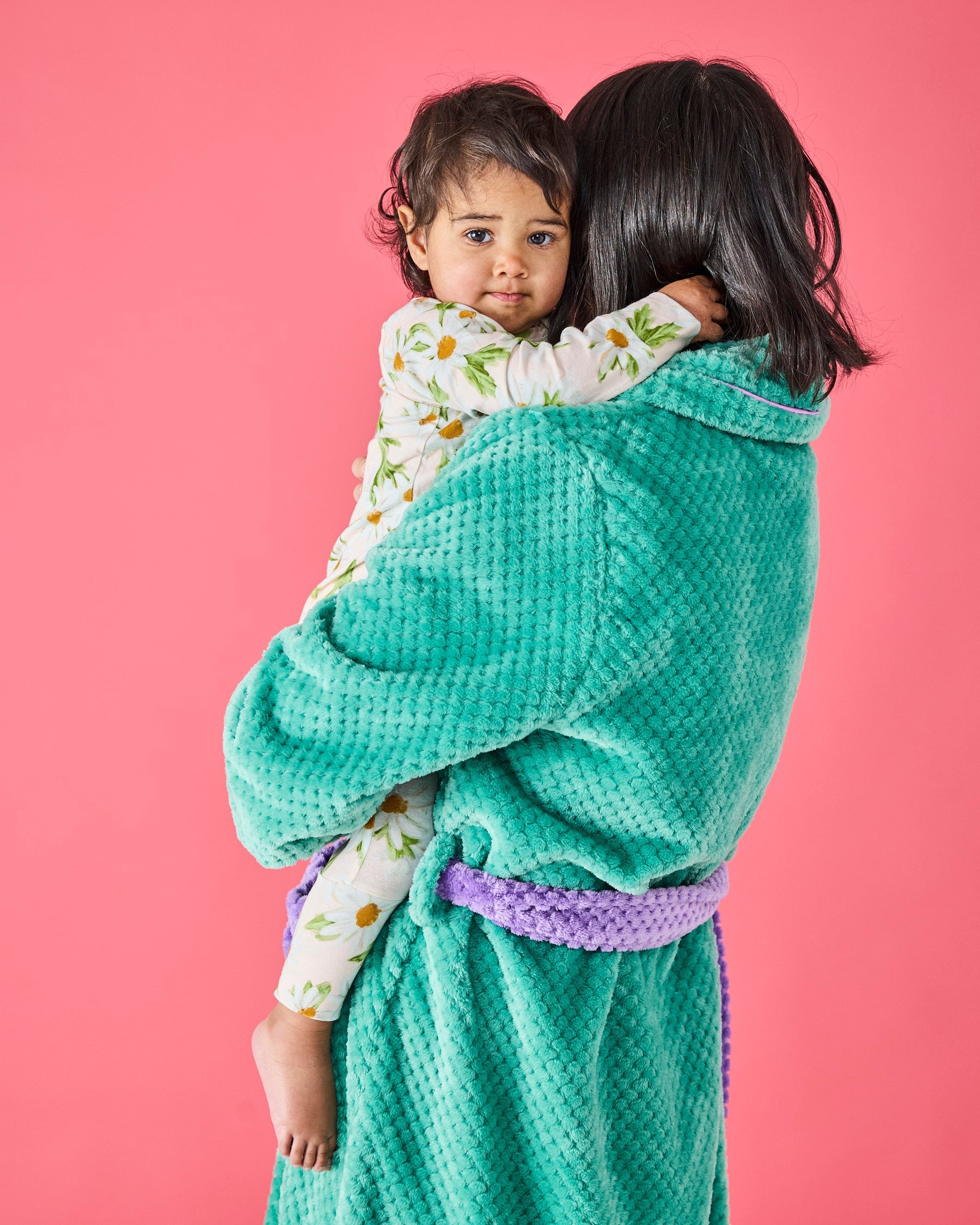 Back view of woman holding child wearing teal Tropicas Adult Cosy Robe with purple waffle texture belt