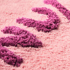 Tula Nudie Rudie Bath Mat Blush Sage & Clare fabric details with purple and pink cotton