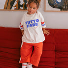 Young girl in the Tutto Fare T-shirt - Buttercream | Golden Children