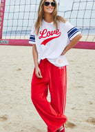 model wearing Urban Love Tee - White by Hammill & Co pair with red velour pants