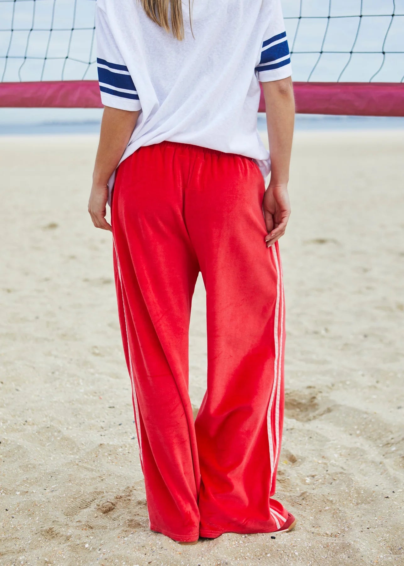 ultra comfortable velour sweat pants by Hammill and co, in red with pink stripes down the side