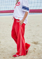 womens red velour track pants with pink stripes and relaxed fit