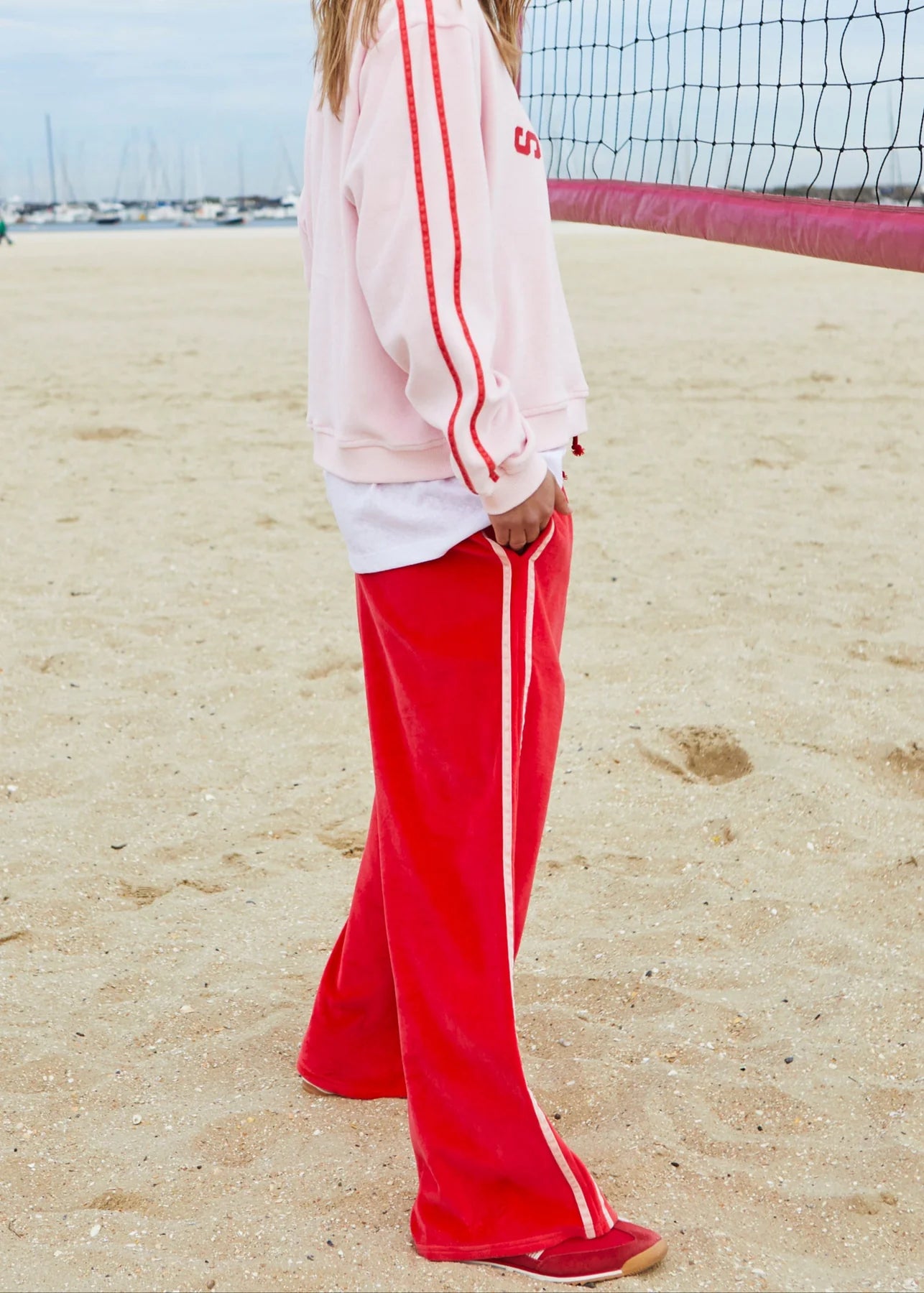 side view of model wearing Urban Velour Pant - Red/Pink by Hammill & Co