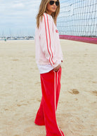 womens pink velour jumper with red stripes on sleeves