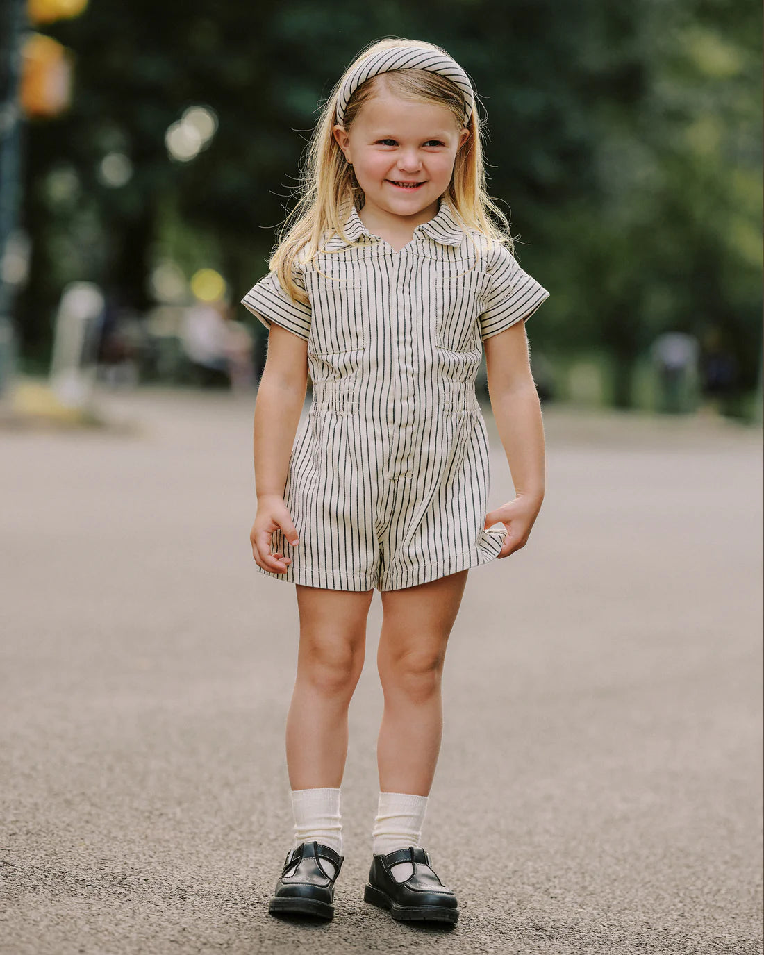 Girl wearing Utility romper navy pinstripe Rylee Cru - kids short sleeve boiler suit