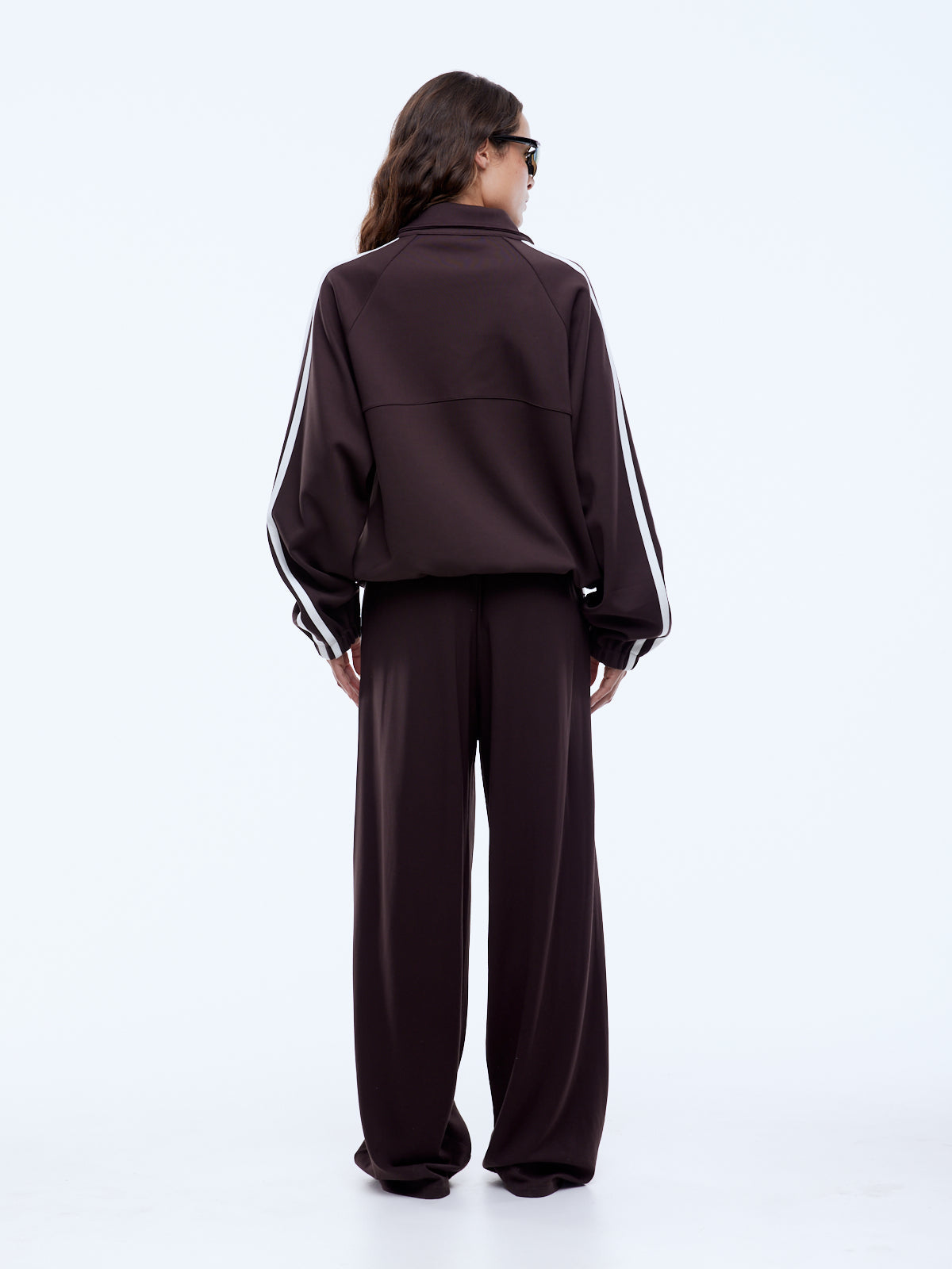 Welt pockets and stacked Ena Pelly logo prints detail on cocoa utility zip jacket