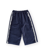 Flat lay of navy velour broderie wide leg pants showing elastic waist and white lace trim