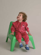 Young child wearing the matching set to the Very Cherry Velour Trackpant | Huxbaby