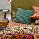 Vinita Velvet Cushion by Sage & Clare on bed