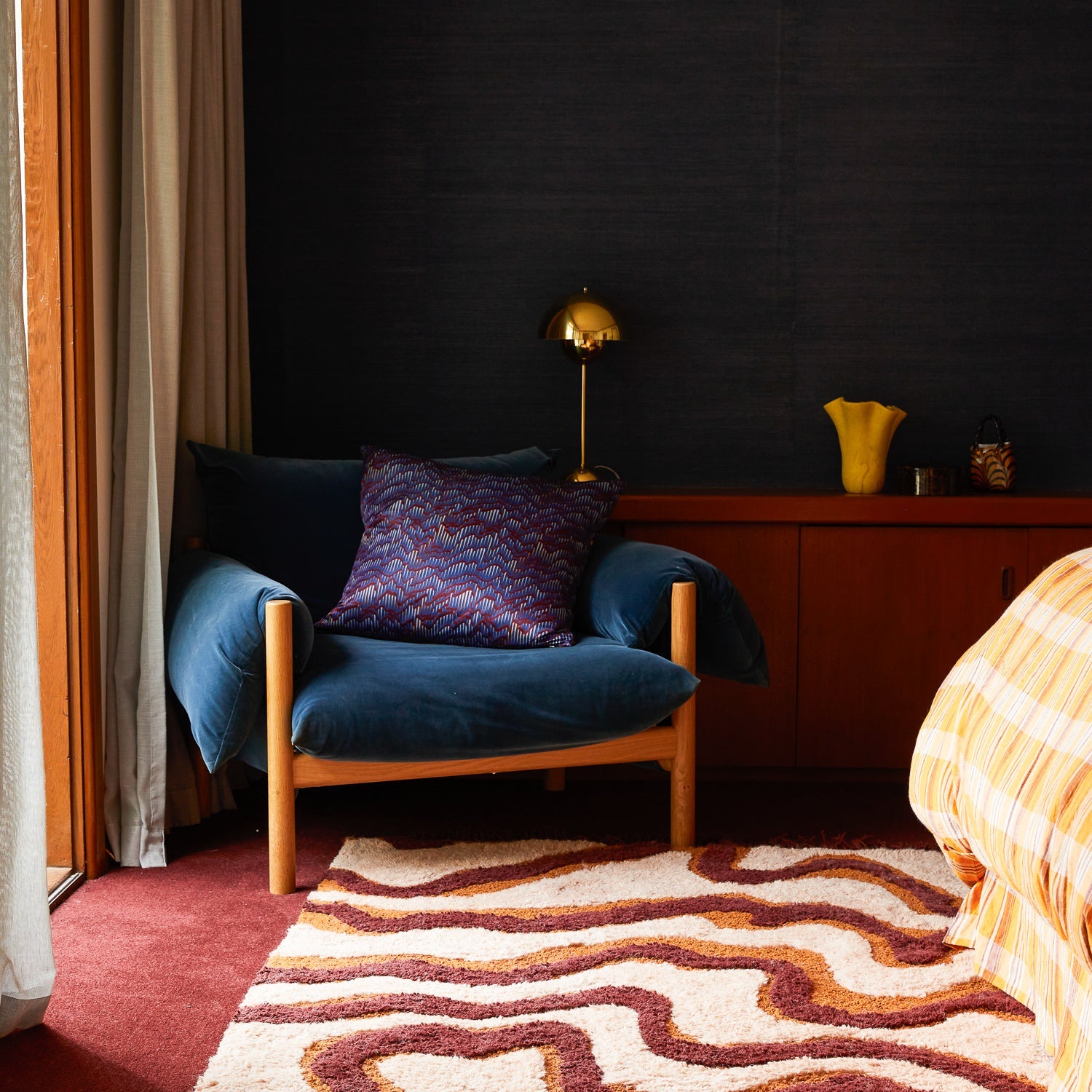 Aspen Gold Violetta Vase sitting on a sideboard in a moody bedroom interior with retro furnishings