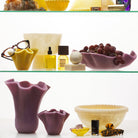Orchid Violetta Vases in two sizes displayed on shelves alongside home and beauty accessories
