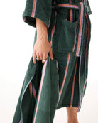 Side view of woman wearing green striped bamboo terry robe showing belt tie and pocket detail