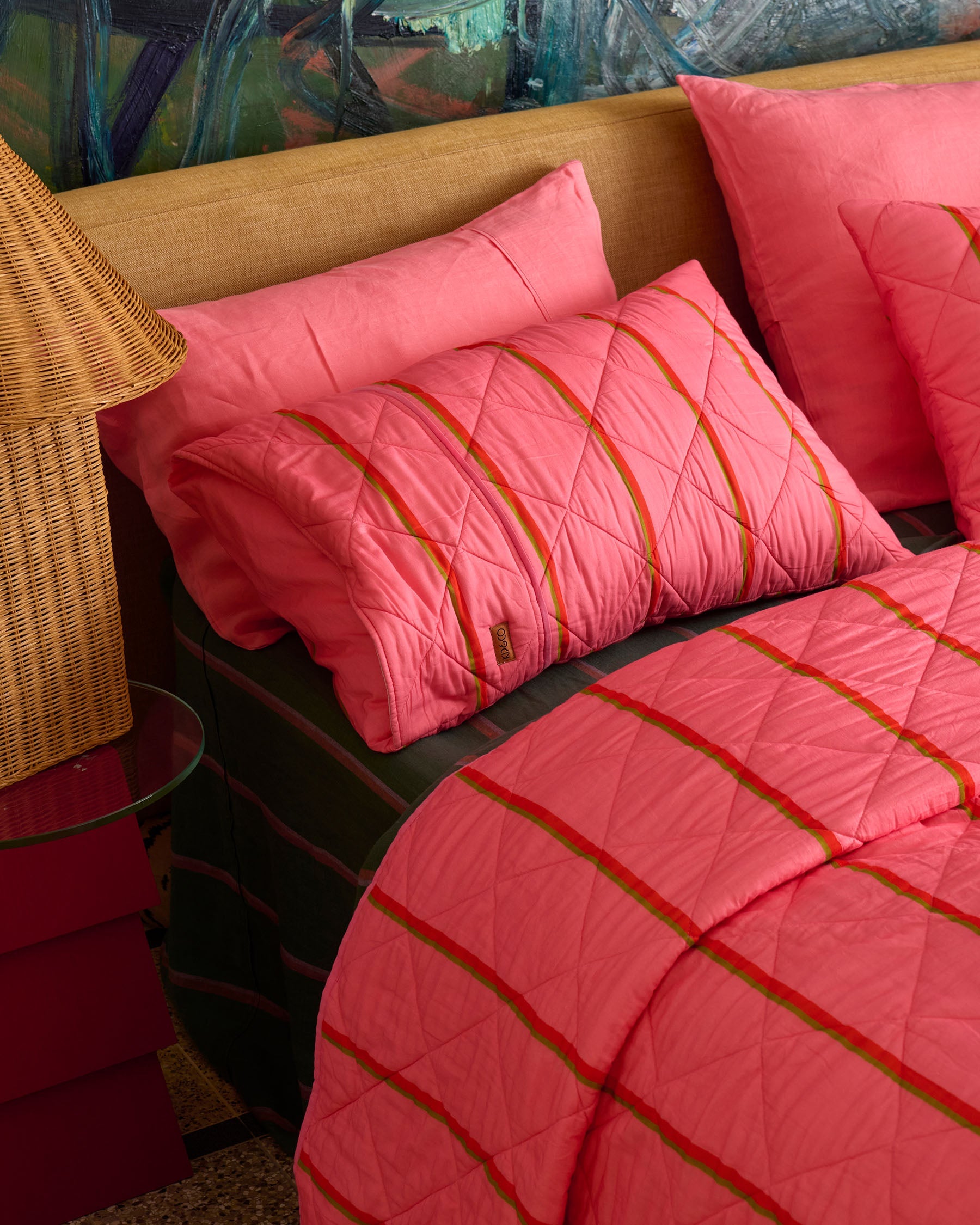 Close-up detail of Wategos Soiree Stripe quilted bedspread pillow showing diamond quilting and orange stripe design