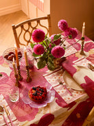 Wild Pansy Pink Tablecloth on dining table with floral centerpiece and table setting