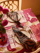 Overhead view of Wild Pansy Pink Tablecloth with place setting and coordinating napkins